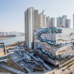 Galleria Gwanggyo, a textured mosaic stone façade that evokes nature