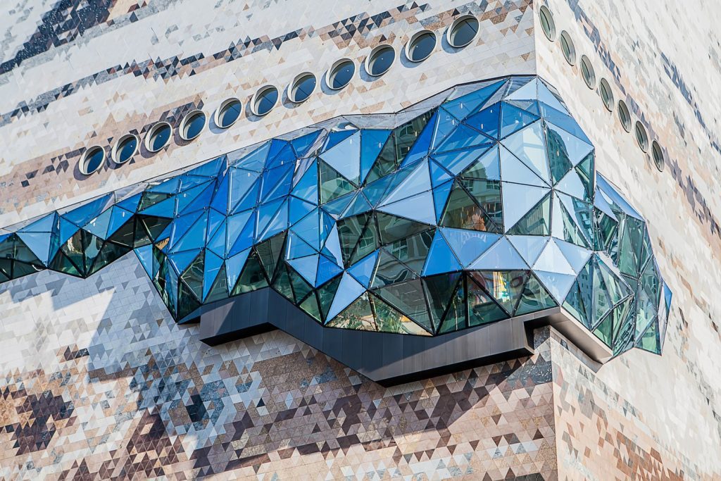 Galleria Gwanggyo, a textured mosaic stone façade that evokes nature