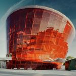 Great Amber Concert Hall enveloped by a tilted glazed facade