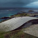 The parabolic roof of 'The Whale' blends with its surroundings, inspired by the whale's journey
