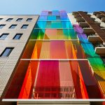 SAKO Architects designed a multicolored glass facade for an office building in Tokyo