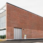 The new Vuosaari Heat Pump Building blends with its surrounding industrial landscape