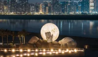 KAWS’s 32-Meter Companion Raises a Glowing Moon in Abu Dhabi