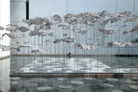 YOKOMAE et BOUAYAD’s stainless-steel pavilion at Louvre Abu Dhabi