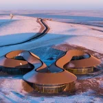 Low-Rise Sculptural Architecture Blends Landscape, Vernacular Form, and Climate-Driven Design