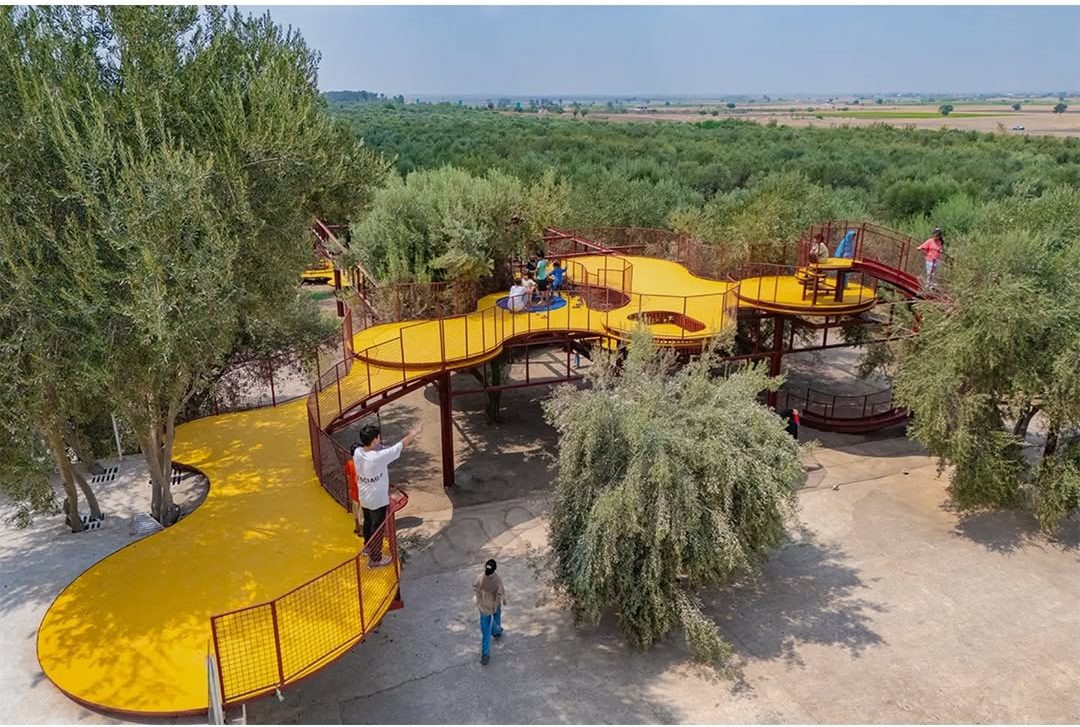 ZAV Architects’ Bright Red and Yellow Playground Cuts Through Iran’s Olive Groves 5 Cheshm Cheran Bazi Playground by ZAV Architects