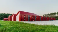 Aranchii Architects Designs a Modular Logistics Hub with Red Sculptural Roofs