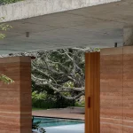 Twin Banyan Trees Define Anonym’s Baan Saikhoo Residence in Thailand