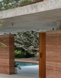 Twin Banyan Trees Define Anonym’s Baan Saikhoo Residence in Thailand