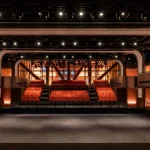 Stage view of Apple Music Hall showing the wide performance area and surrounding seating