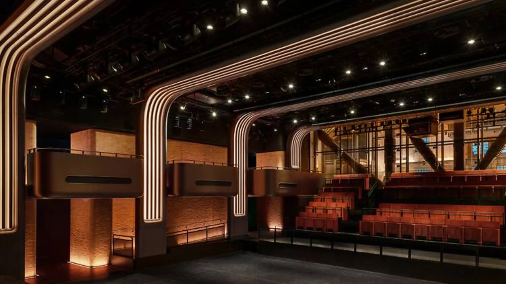 Wide interior shot of Apple Music Hall looking toward the stage under warm lighting