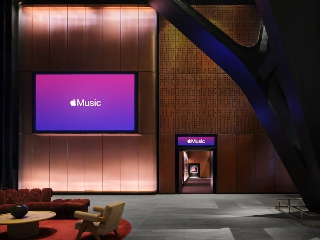 Broadcast or media wall displaying Apple Music branding inside the venue