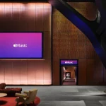 Broadcast or media wall displaying Apple Music branding inside the venue