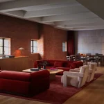Lounge or green-room area with red seating and soft lighting
