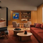 Comfortable seating area with sofas, tables and warm wood tones