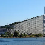 Can architecture really solve social problems? This critical essay examines Bjarke Ingels’ optimistic design philosophy, public architecture, sustainability, accessibility, and the limits of architectural agency.