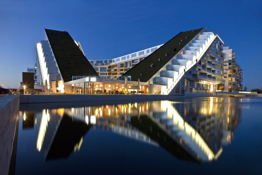 Can architecture really solve social problems? This critical essay examines Bjarke Ingels’ optimistic design philosophy, public architecture, sustainability, accessibility, and the limits of architectural agency.