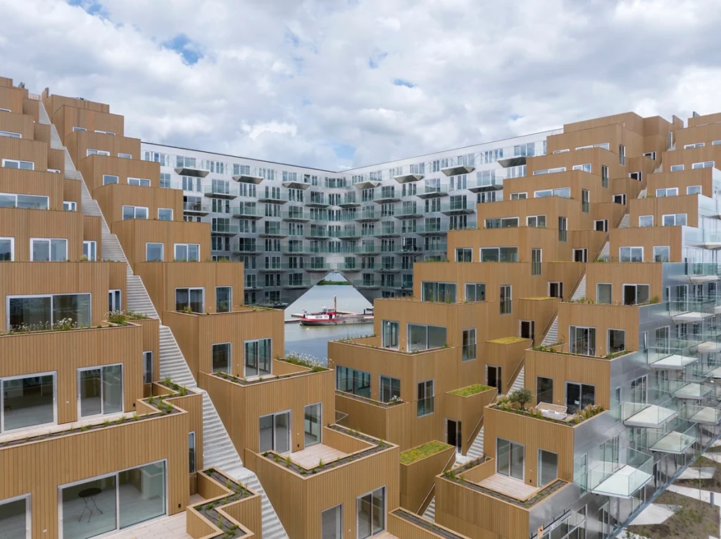 Can architecture really solve social problems? This critical essay examines Bjarke Ingels’ optimistic design philosophy, public architecture, sustainability, accessibility, and the limits of architectural agency.