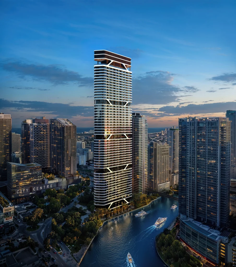 Full view of the 60-storey Bugatti Residences Miami rising beside the Miami River at dusk
