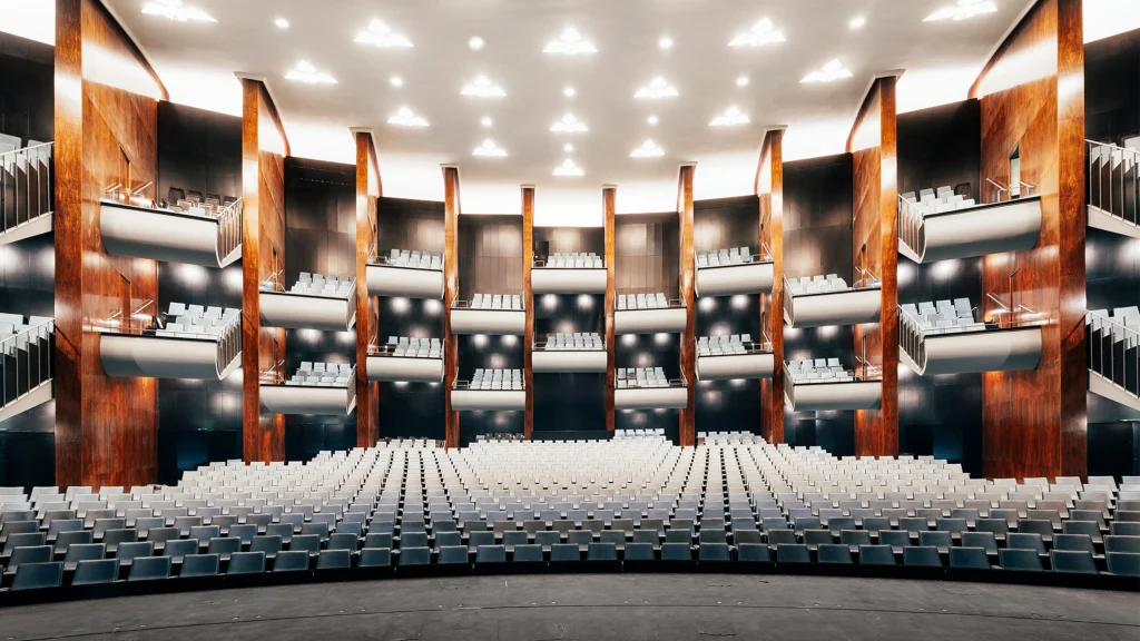 nterior view of the renovated Bühnen Köln auditorium with warm wood tones and curved seating