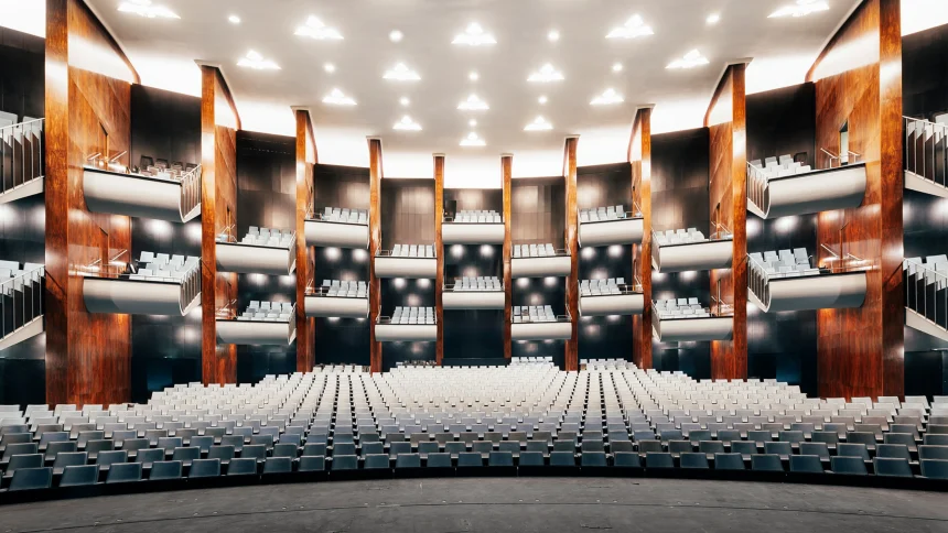 nterior view of the renovated Bühnen Köln auditorium with warm wood tones and curved seating