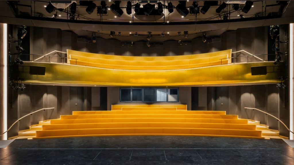 Stage and auditorium of theCologne’s Municipal Theatre with golden proscenium and tiered seating