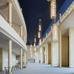 Curved foyer corridor with vertical light fittings and smooth surfaces