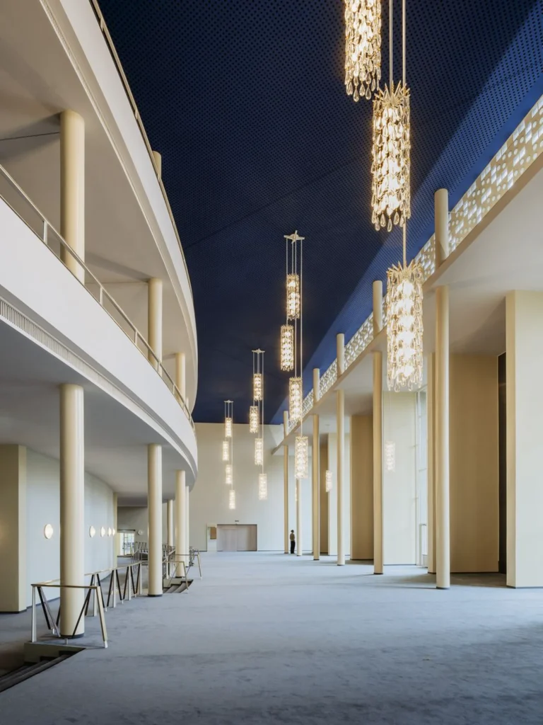Curved foyer corridor with vertical light fittings and smooth surfaces