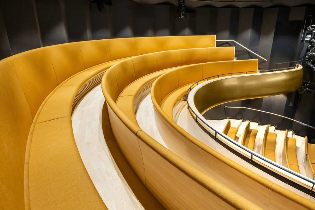 Sweeping golden staircase and curved wall within the new Children’s Opera volume