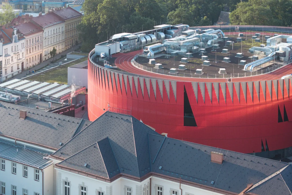 Aerial view of the elliptical red arena and surrounding buildings