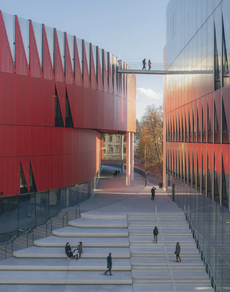 Close-up of the red aluminium facade with triangular panels and integrated lighting