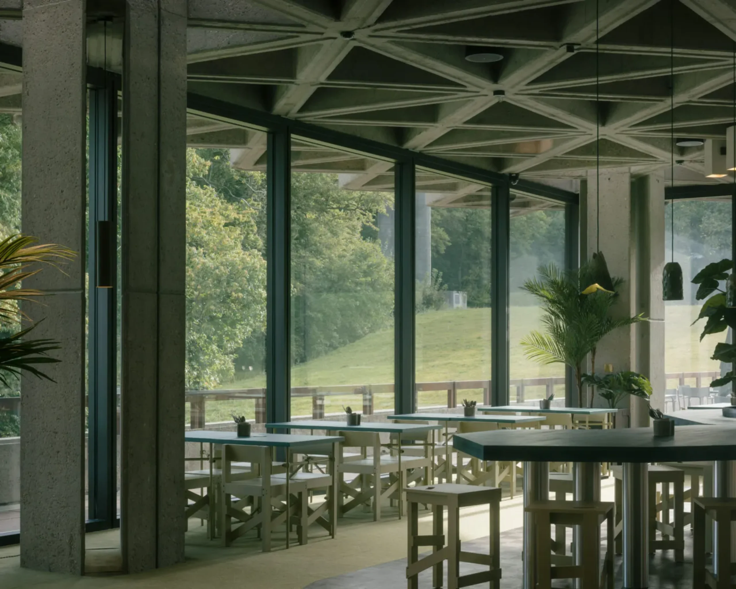 Glass-walled interior area overlooking greenery at Royale Belge