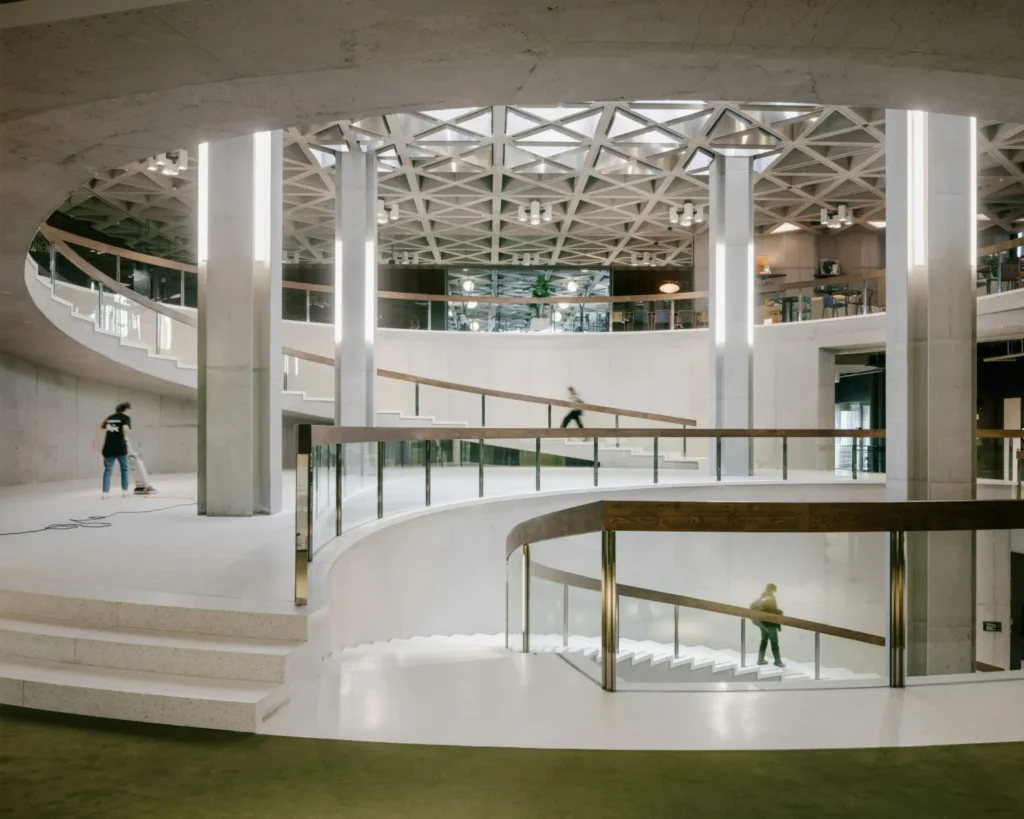 Multi-level interior view with staircase, columns and natural light
