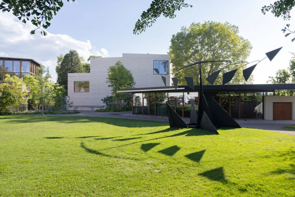 Wider park view showing the new buildings set within the lawn and mature trees