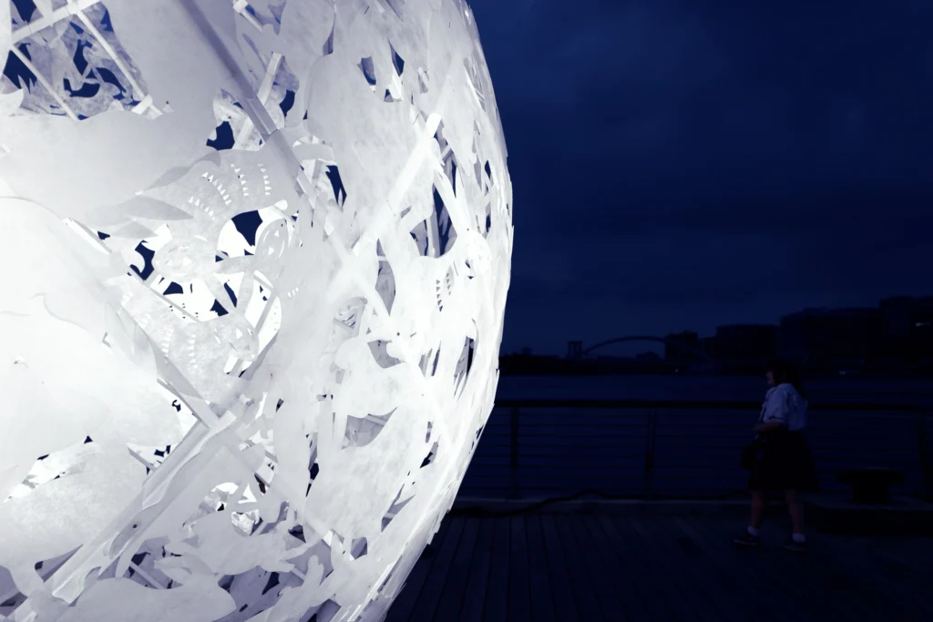 The Full Moon: Close-up of the white rabbit cut-outs that form the surface of the sphere at night