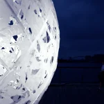 Close-up of the white rabbit cut-outs that form the surface of the sphere at night