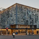 Exterior view of a City Rail Link station with patterned aluminium façade panels