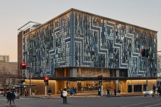 Exterior view of a City Rail Link station with patterned aluminium façade panels