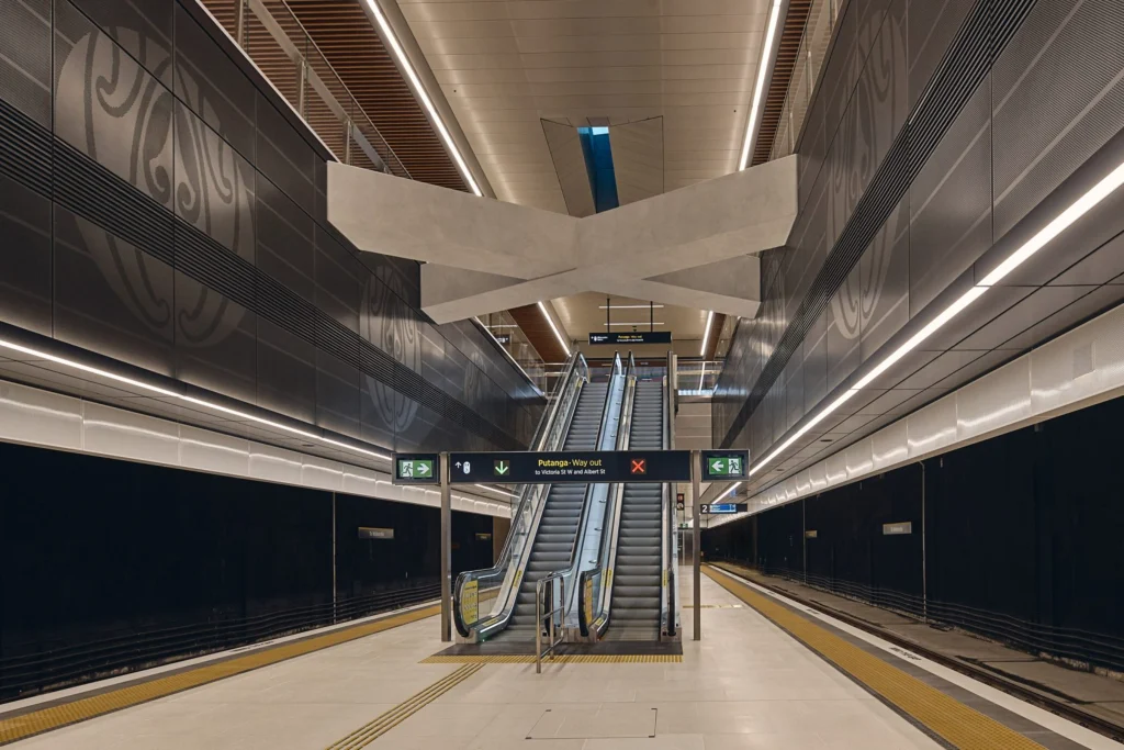 Underground platform level with clean lines, lighting and waiting passengers