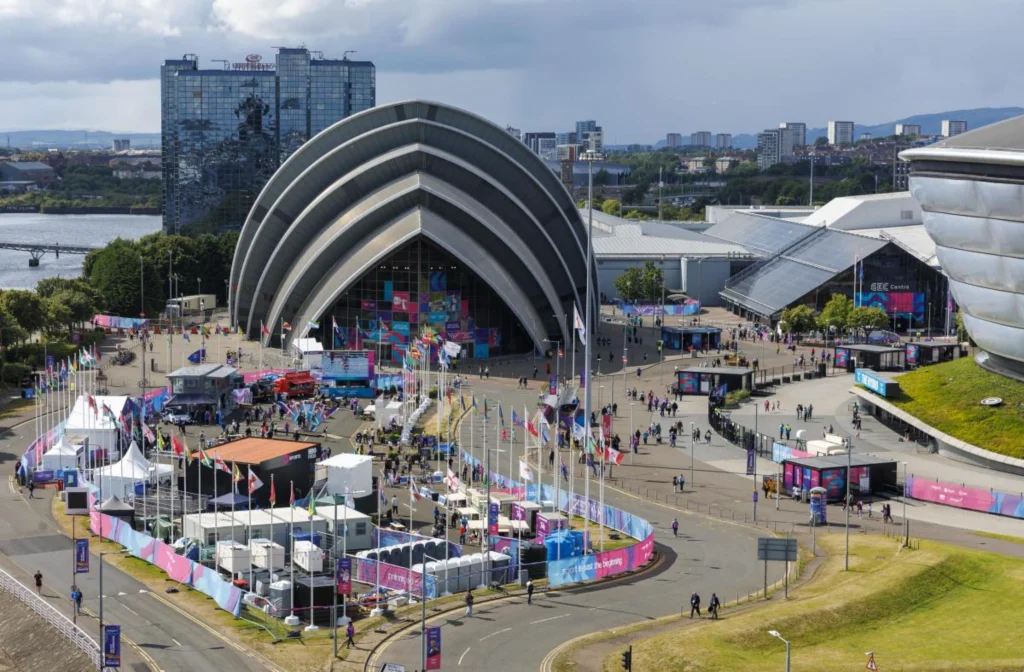 Ground-level view of the SEC Armadillo during an outdoor event with crowds and temporary structures