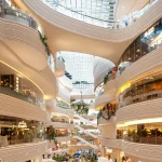 Biophilic interiors and ecological corridors create a calm, nature-immersive atmosphere inside the retail floors.