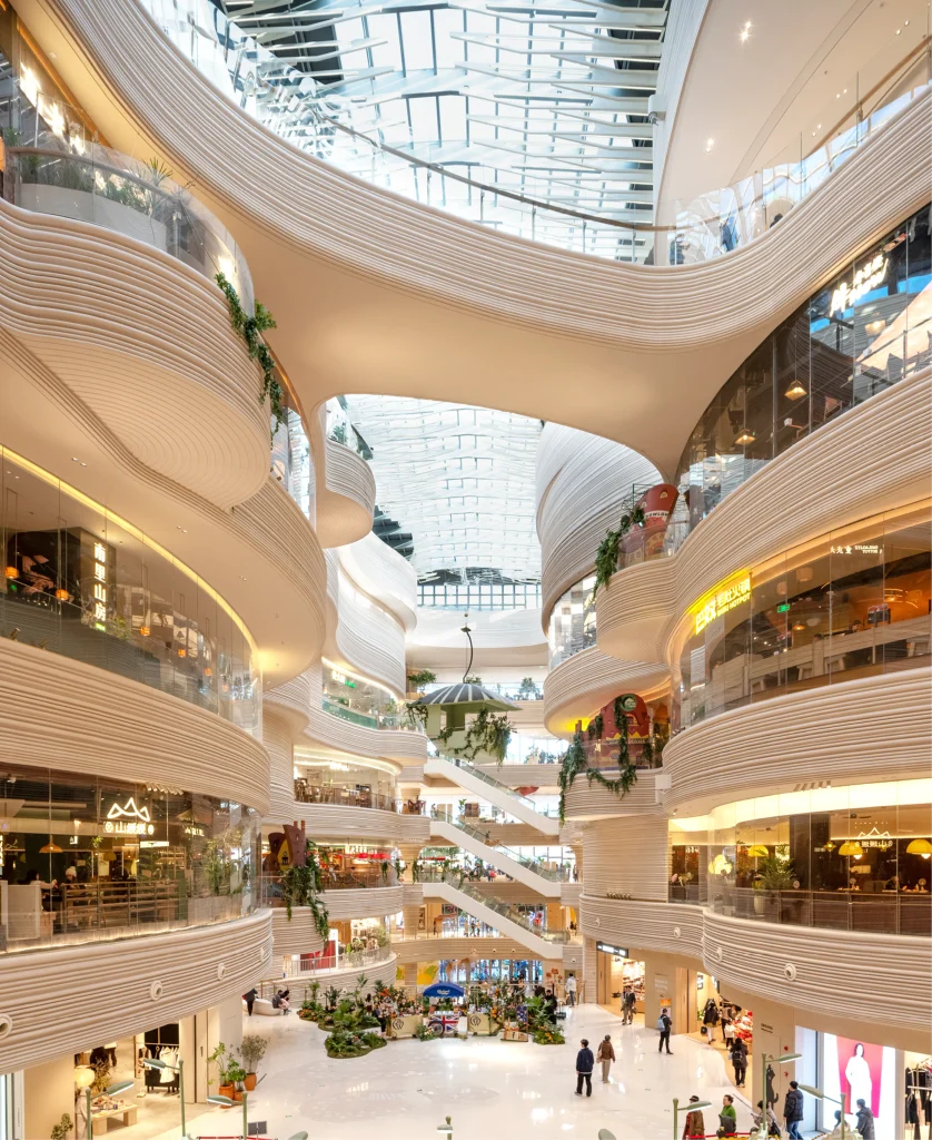 Biophilic interiors and ecological corridors create a calm, nature-immersive atmosphere inside the retail floors.
