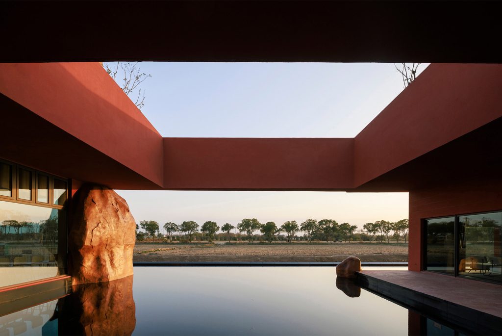 Jiashan Dayun Landison Manor Central courtyard with a single tree reflected in a still pool framed by water curtains