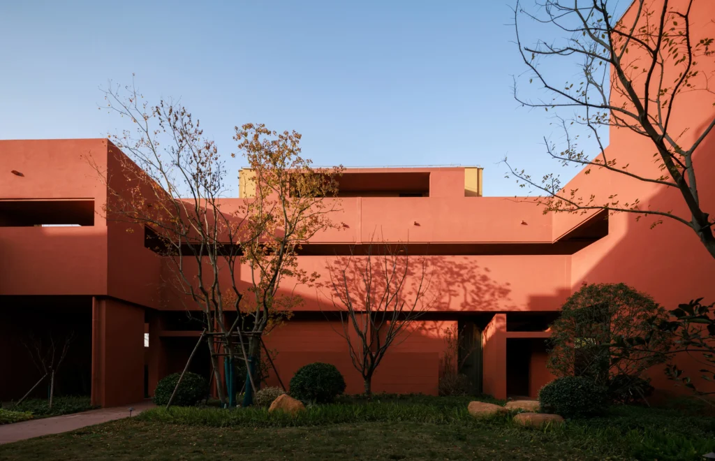 Courtyard space with trees and geometric terracotta forms