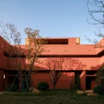 Courtyard space with trees and geometric terracotta forms