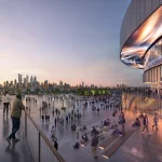 Exterior rendering of the Populous-designed Philadelphia arena at dusk, showing fans crossing a wide plaza beneath a curved, cantilevered band extending from the facade, with the city skyline in the distance.