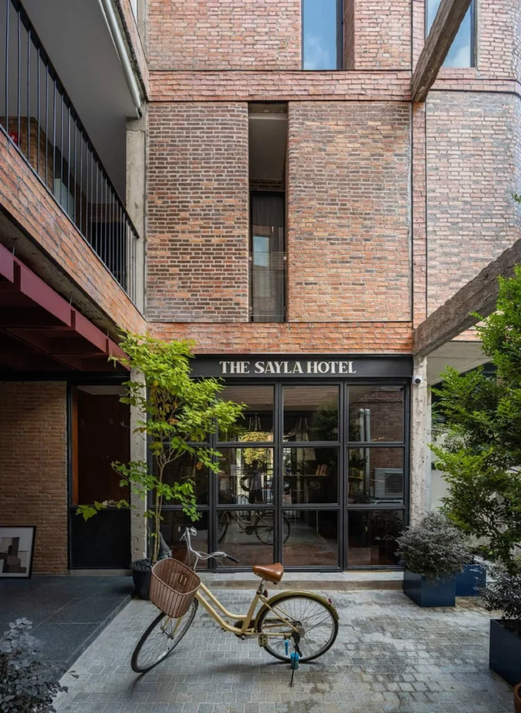 Ground-floor entrance and courtyard edge with bicycle and potted plants