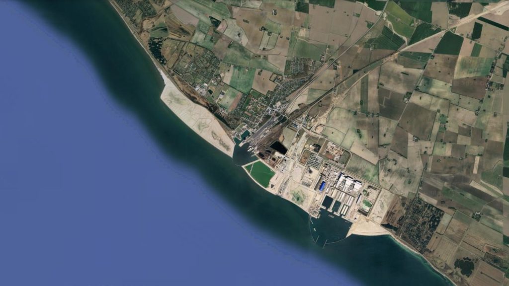 Aerial view of the newly reclaimed coastal land with sandy surface and breakwater along the Danish shore