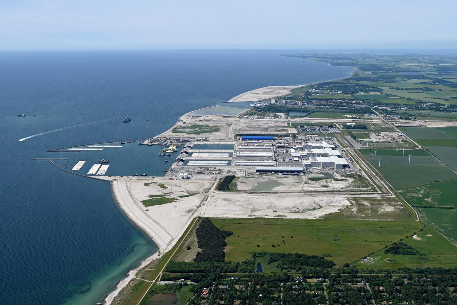 Wider aerial showing Denmark's reclamation area, industrial facilities and surrounding coastline