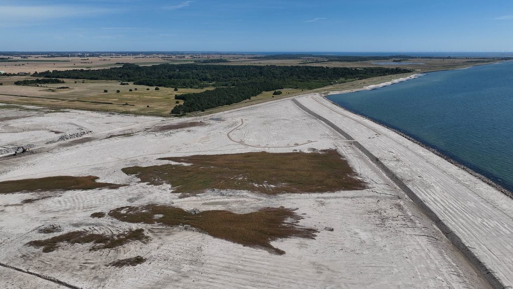 Satellite-style view of the curved coastline and reclamation zone beside open water